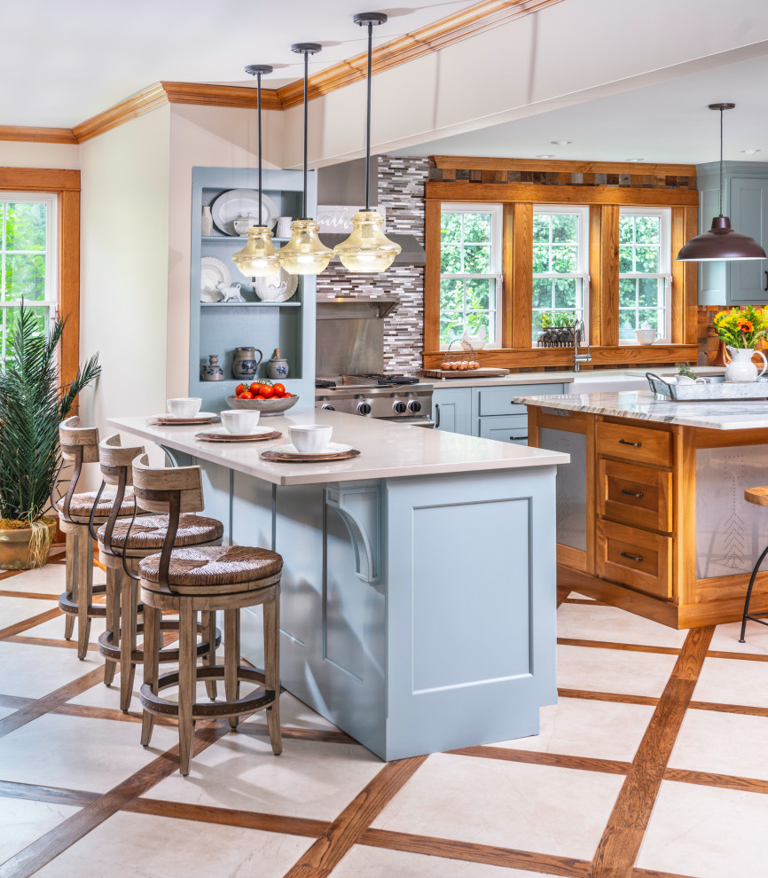 Kitchen - huge country porcelain tile and beige floor kitchen idea in Nashville with a farmhouse sink, shaker cabinets, blue cabinets, marble countertops, brown backsplash, wood backsplash, stainless steel appliances, an island and multicolored countertops