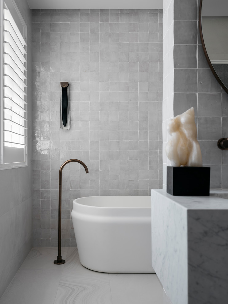 Large contemporary master bathroom in Sydney with a freestanding tub, white tile, stone tile, white walls, ceramic floors, an undermount sink, granite benchtops, white floor and white benchtops.
