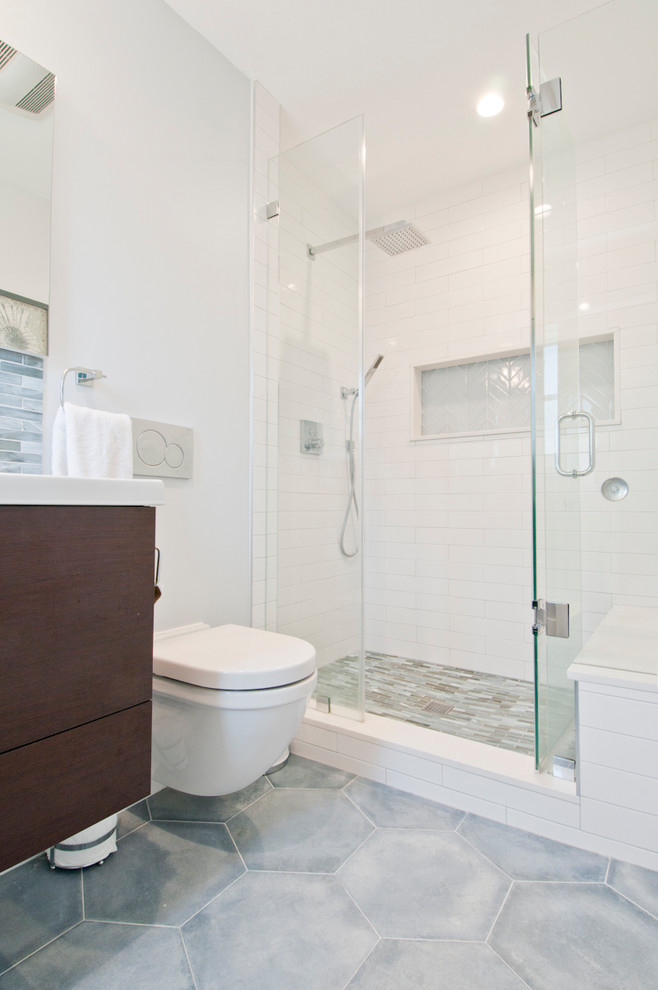 Mid-sized contemporary master bathroom in Los Angeles with flat-panel cabinets, dark wood cabinets, an alcove shower, a one-piece toilet, blue tile, glass tile, white walls, porcelain floors, an integrated sink, quartzite benchtops, blue floor, a hinged shower door and white benchtops.
