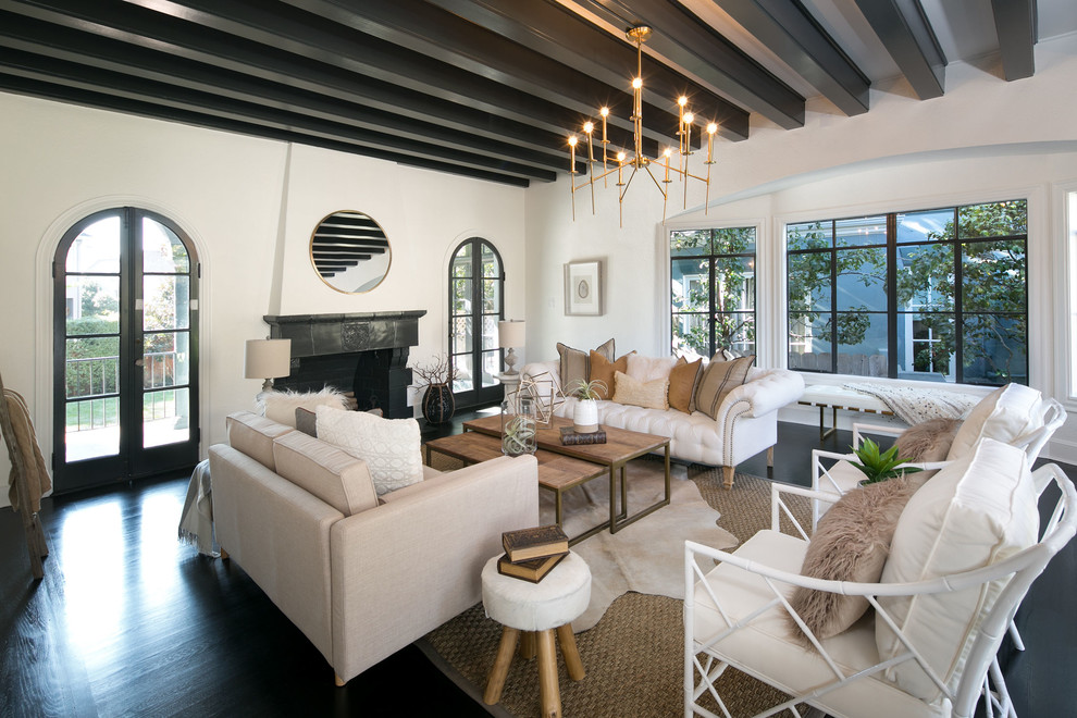Large mediterranean formal enclosed living room in San Francisco with white walls, dark hardwood floors, a standard fireplace, a tile fireplace surround, no tv and black floor.