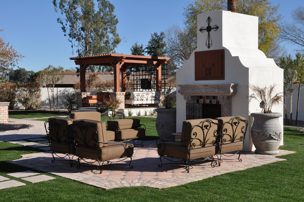 Design ideas for a mediterranean patio in Phoenix with with fireplace.
