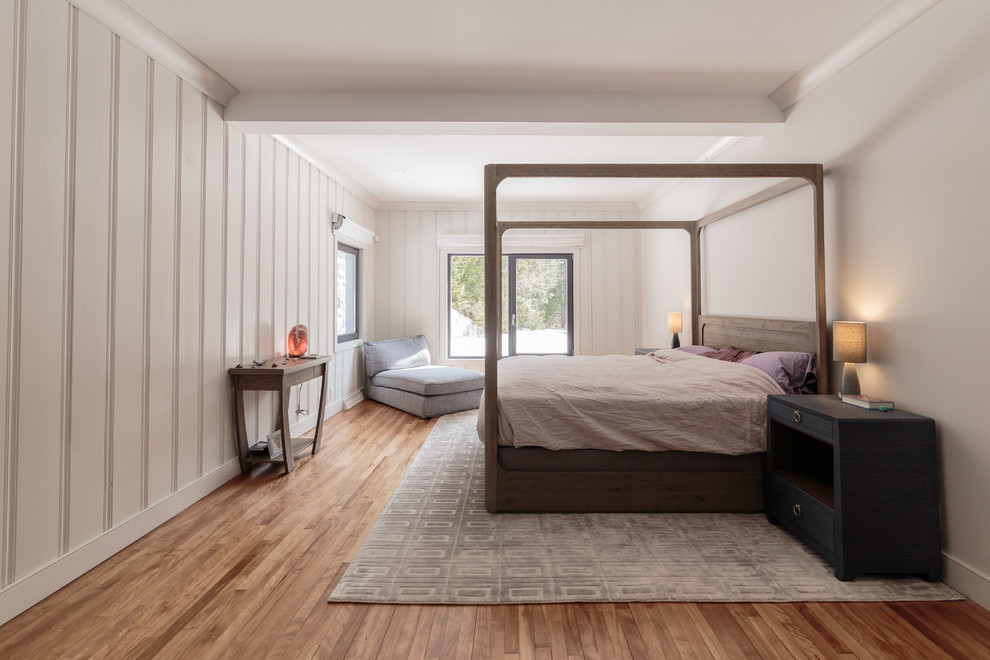 Design ideas for a mid-sized scandinavian master bedroom in Montreal with white walls, light hardwood floors, no fireplace and brown floor.