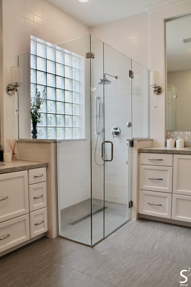 Photo of a large transitional master bathroom in Houston with recessed-panel cabinets, white cabinets, a freestanding tub, a curbless shower, a one-piece toilet, white tile, porcelain tile, grey walls, porcelain floors, an undermount sink, quartzite benchtops, grey floor, a hinged shower door, grey benchtops, a niche, a double vanity and a built-in vanity.