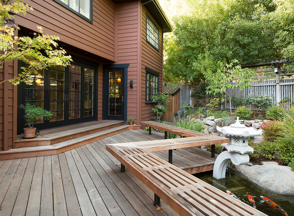 Asian backyard deck in San Francisco with a water feature and no cover.