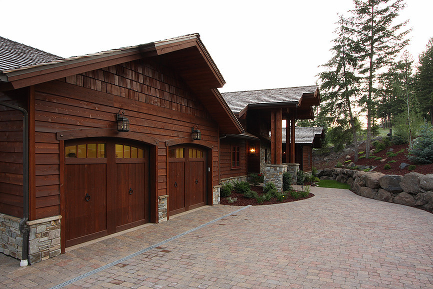 This is an example of a large arts and crafts two-storey brown exterior in Seattle with wood siding and a gable roof.