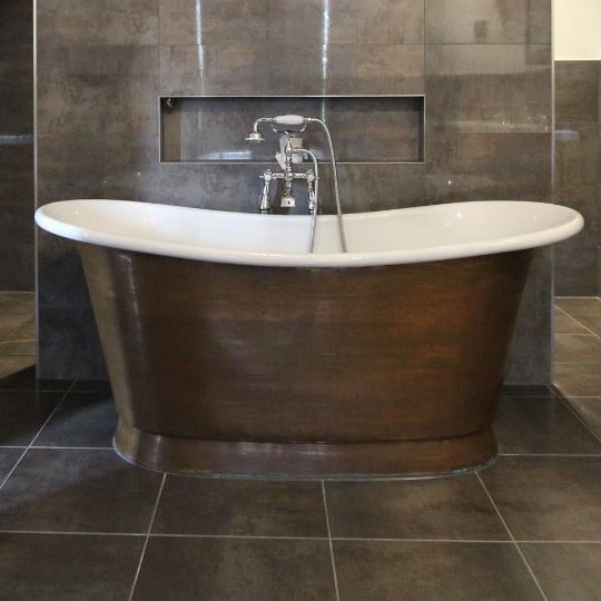 Photo of an expansive modern bathroom in Sussex with a freestanding tub, a wall-mount toilet, gray tile, porcelain tile, grey walls, porcelain floors and with a sauna.