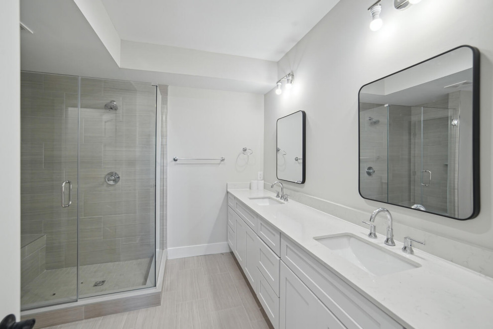This is an example of a large transitional master bathroom in DC Metro with shaker cabinets, white cabinets, a corner shower, engineered quartz benchtops, a hinged shower door, white benchtops, a shower seat, a double vanity and a built-in vanity.