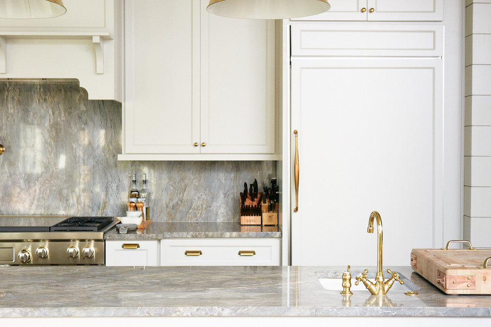 Inspiration for a large transitional l-shaped medium tone wood floor and brown floor eat-in kitchen remodel with a farmhouse sink, raised-panel cabinets, white cabinets, marble countertops, gray backsplash, marble backsplash, stainless steel appliances, an island and gray countertops