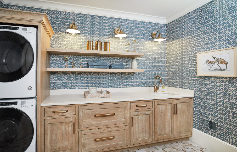 Design ideas for a single-wall separated utility room in Grand Rapids with a submerged sink, beaded cabinets, distressed cabinets, engineered stone countertops, blue walls, ceramic flooring, a stacked washer and dryer, beige floors, white worktops, wallpapered walls and feature lighting.
