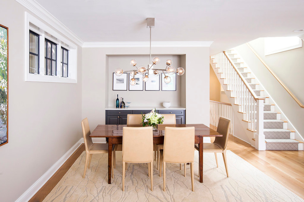 Photo of a transitional dining room in Chicago with beige walls and light hardwood floors.