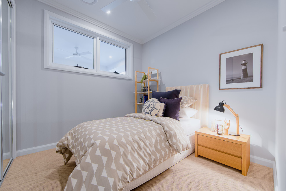 This is an example of a beach style guest bedroom in Gold Coast - Tweed with blue walls, carpet and beige floor.