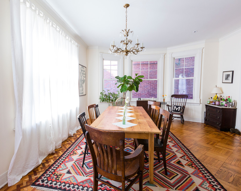 Photo of a large traditional dining room in New York with white walls and medium hardwood floors.