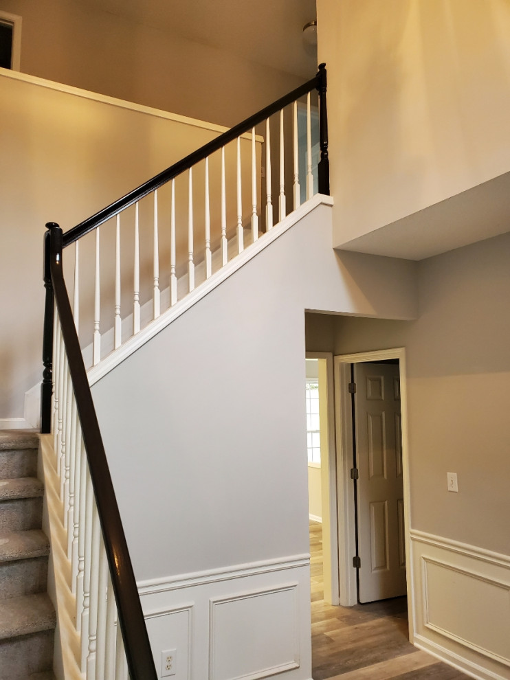 Inspiration for a mid-sized modern vinyl floor foyer remodel with beige walls
