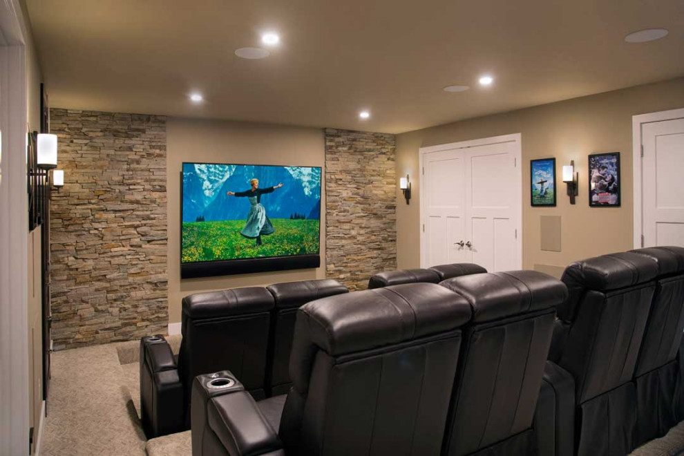Design ideas for a large transitional enclosed home theatre in Other with beige walls, carpet, a wall-mounted tv and beige floor.