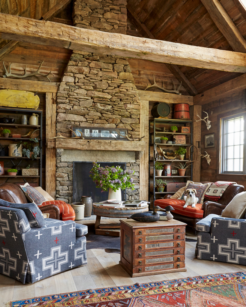 Inspiration for a rustic light wood floor and beige floor living room remodel in New York with a standard fireplace and a stone fireplace