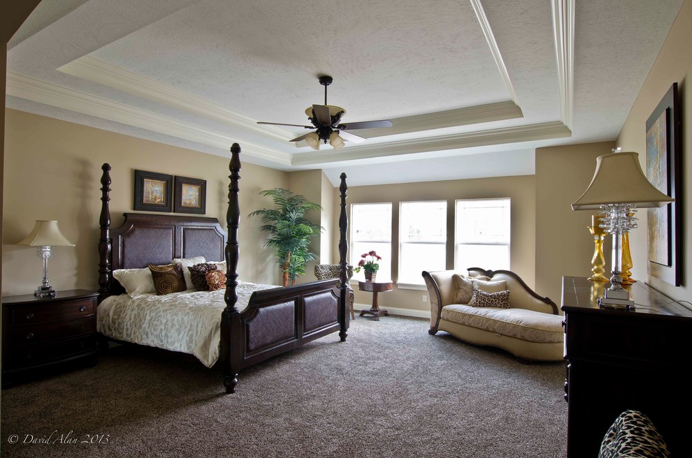 Design ideas for a large traditional master bedroom in Cleveland with beige walls and carpet.