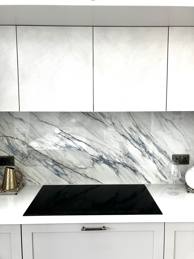 Inspiration for a contemporary kitchen in London with shaker cabinets, quartzite benchtops, blue splashback and with island.