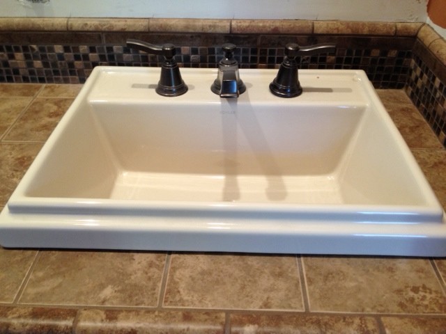 Example of a transitional gray tile and mosaic tile bathroom design in Orange County with a drop-in sink and tile countertops