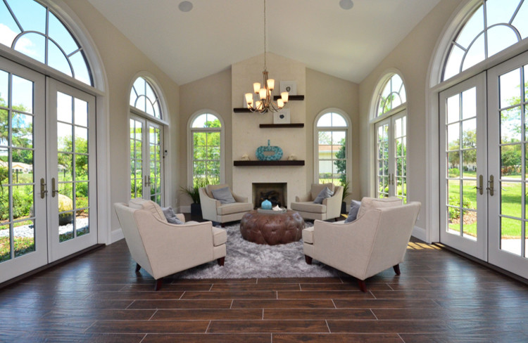 Inspiration for a mid-sized contemporary formal enclosed living room in Orlando with beige walls, dark hardwood floors, a standard fireplace, a plaster fireplace surround, no tv and brown floor.