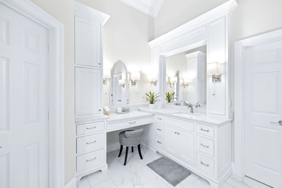 Photo of a medium sized classic ensuite bathroom in Atlanta with shaker cabinets, white cabinets, a built-in bath, a built-in shower, a one-piece toilet, white tiles, porcelain tiles, grey walls, porcelain flooring, a submerged sink, quartz worktops, white floors, a hinged door, white worktops, a wall niche, a single sink, a built in vanity unit and a vaulted ceiling.