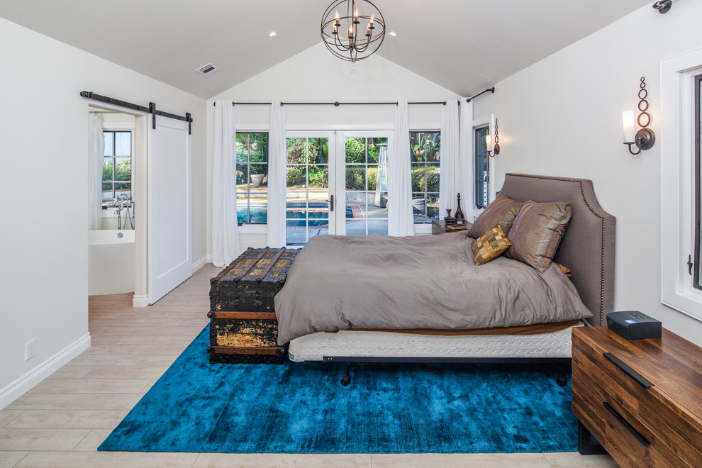 This is an example of a large transitional master bedroom in San Diego with grey walls, porcelain floors and brown floor.