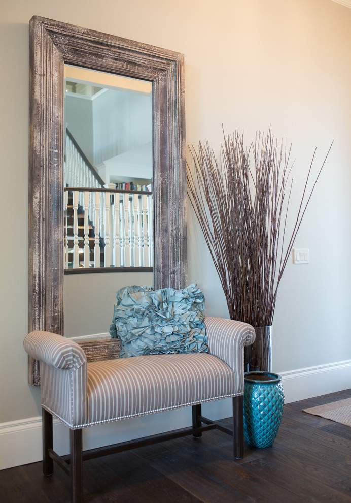 Foyer - large transitional dark wood floor foyer idea in Calgary with gray walls and a medium wood front door