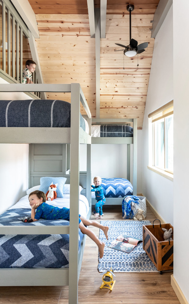 Example of a large mountain style carpeted, beige floor and exposed beam kids' room design in Other with multicolored walls