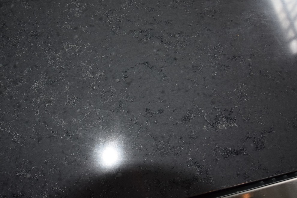 Inspiration for a small transitional l-shaped light wood floor kitchen remodel with an undermount sink, shaker cabinets, white cabinets, quartz countertops, multicolored backsplash, ceramic backsplash, stainless steel appliances and a peninsula