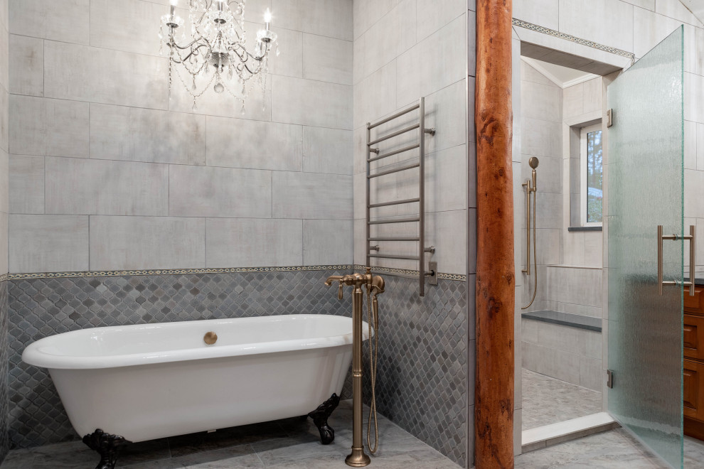 This is an example of a large country master bathroom in Seattle with dark wood cabinets, a claw-foot tub, an alcove shower, a one-piece toilet, gray tile, ceramic tile, white walls, porcelain floors, a drop-in sink, engineered quartz benchtops, grey floor, a hinged shower door, grey benchtops, a double vanity, a built-in vanity and a shower seat.