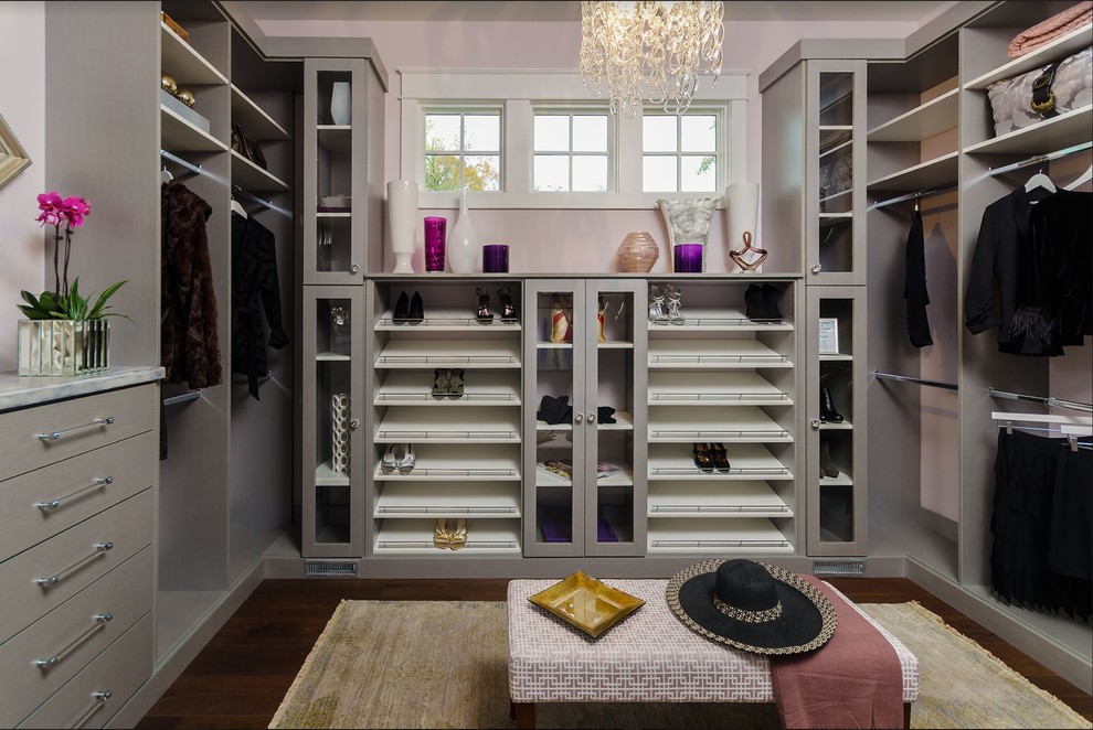 Example of a mid-sized transitional women's dark wood floor and brown floor dressing room design in Houston with open cabinets and gray cabinets