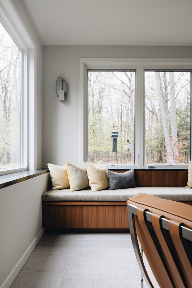 Immagine di un soggiorno minimalista aperto con angolo bar, pareti beige, pavimento in gres porcellanato e pavimento grigio