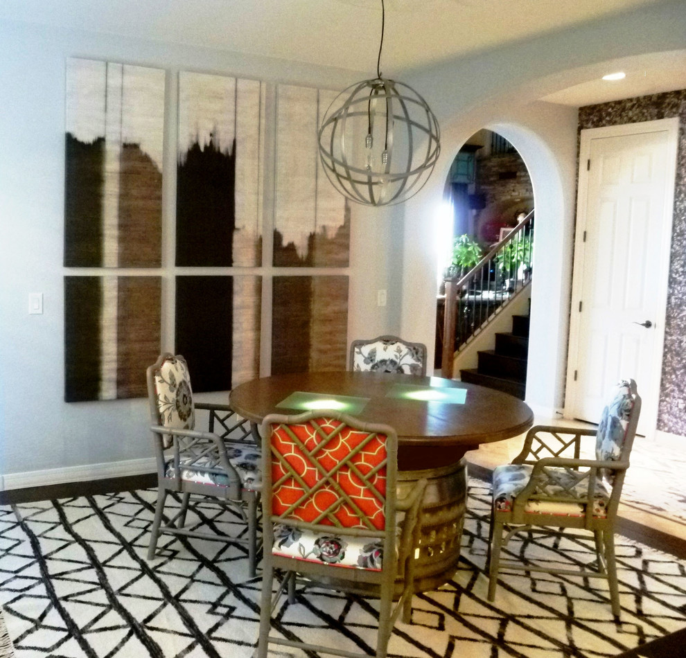 Inspiration for a mid-sized industrial medium tone wood floor enclosed dining room remodel in Phoenix with gray walls