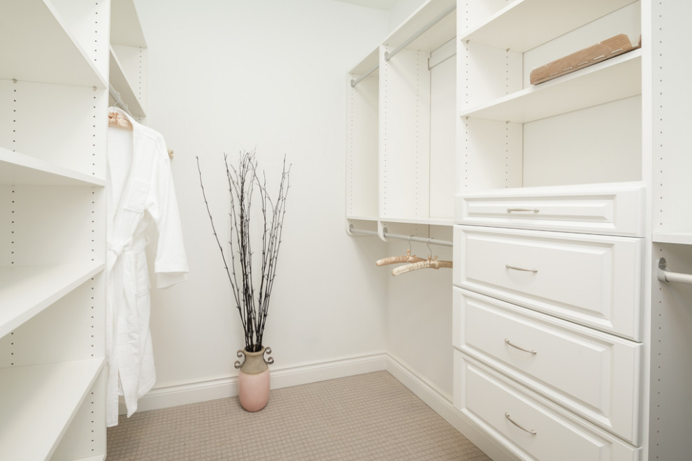 Design ideas for a large transitional gender-neutral walk-in wardrobe in Atlanta with raised-panel cabinets, white cabinets, carpet and beige floor.