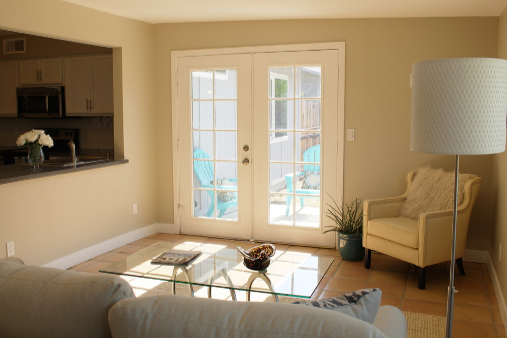 Example of a small transitional l-shaped terra-cotta tile eat-in kitchen design in Phoenix with a drop-in sink, shaker cabinets, white cabinets, quartzite countertops, white backsplash, mosaic tile backsplash, stainless steel appliances and a peninsula
