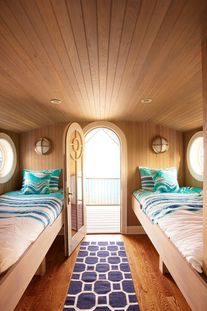 Bedroom - mid-sized coastal loft-style medium tone wood floor and brown floor bedroom idea in New York with brown walls and no fireplace
