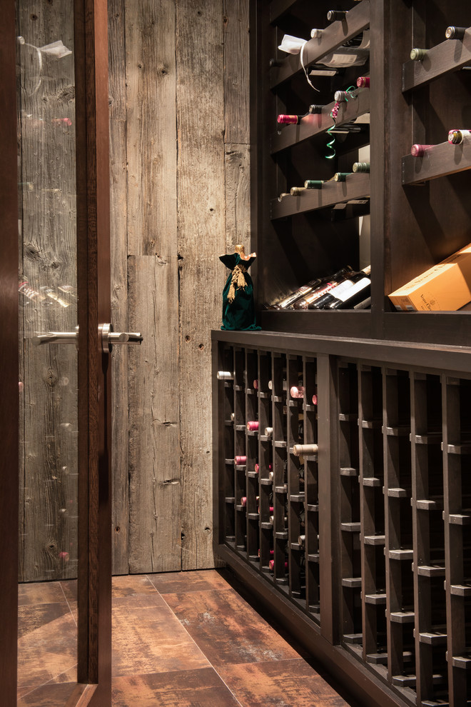 Photo of a mid-sized contemporary wine cellar in Denver with porcelain floors, storage racks and brown floor.