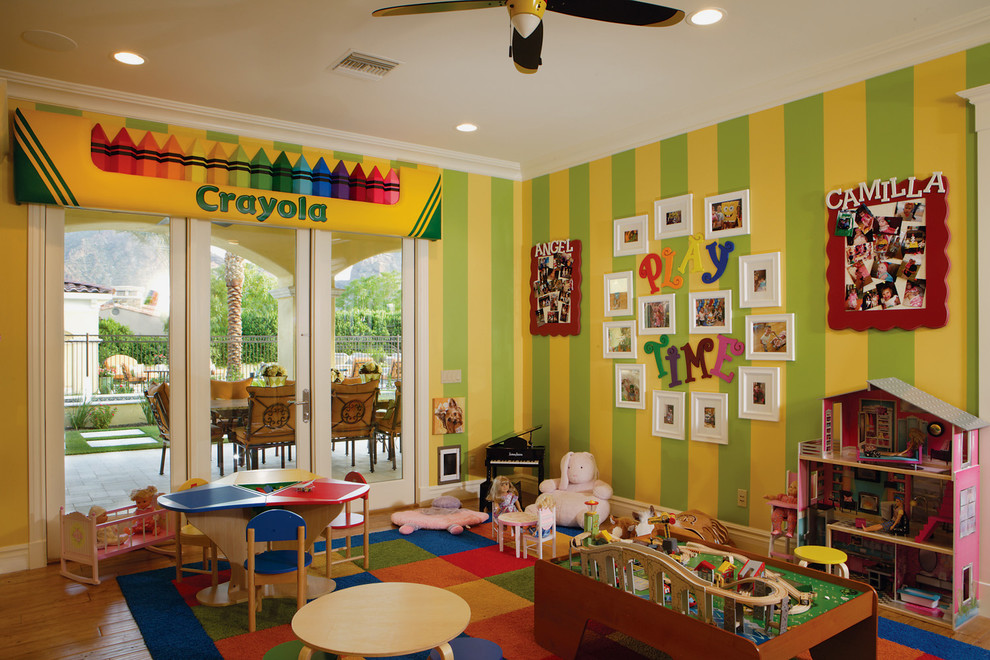 Photo of an expansive transitional gender-neutral kids' room in Phoenix with medium hardwood floors and multi-coloured walls.