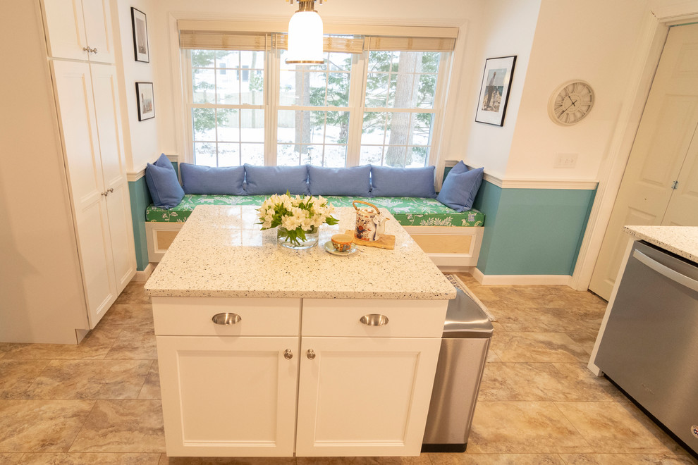 Mid-sized transitional u-shaped beige floor enclosed kitchen photo in Boston with an undermount sink, recessed-panel cabinets, white cabinets, blue backsplash, subway tile backsplash, stainless steel appliances, an island and beige countertops