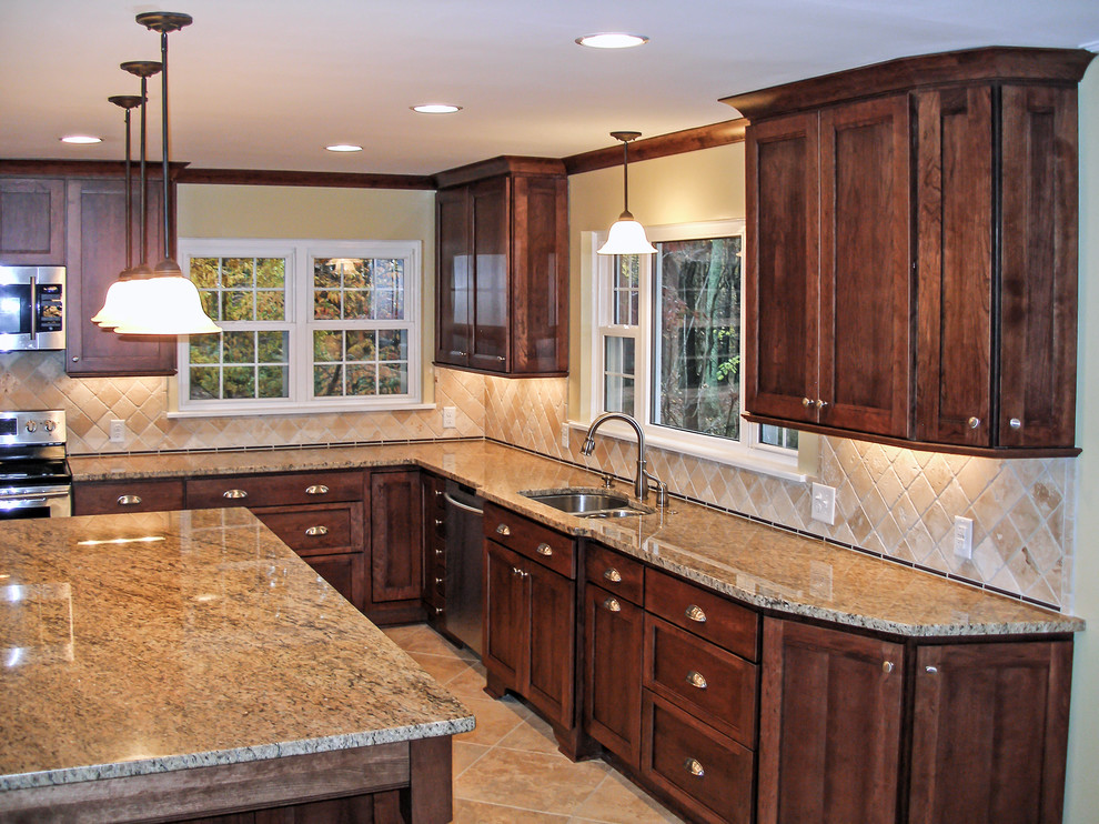 Inspiration for a large transitional u-shaped ceramic tile eat-in kitchen remodel in Charlotte with an undermount sink, recessed-panel cabinets, dark wood cabinets, granite countertops, beige backsplash, stone tile backsplash, stainless steel appliances and beige walls