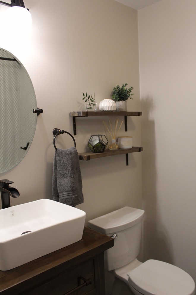 Small country kids bathroom in Chicago with furniture-like cabinets, medium wood cabinets, an alcove tub, a shower/bathtub combo, a one-piece toilet, white tile, ceramic tile, grey walls, ceramic floors, a vessel sink, wood benchtops, grey floor and a shower curtain.