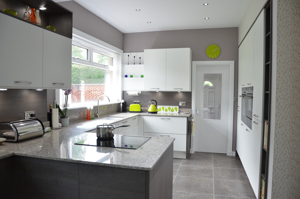 Design ideas for a contemporary u-shaped kitchen in Glasgow with a single-bowl sink, flat-panel cabinets, white cabinets, stone slab splashback and a peninsula.
