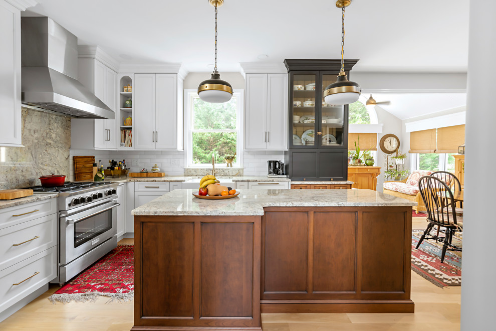 Design ideas for a mid-sized traditional l-shaped separate kitchen in Philadelphia with a farmhouse sink, recessed-panel cabinets, granite benchtops, white splashback, ceramic splashback, stainless steel appliances, light hardwood floors, with island, beige floor and multi-coloured benchtop.