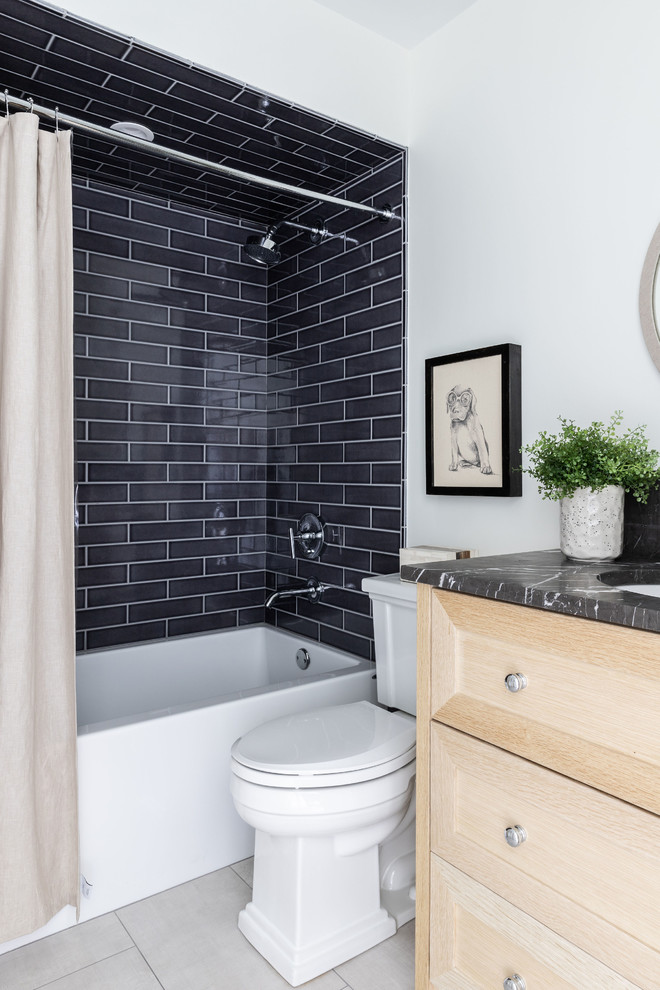 Derby House Kids Wing - New boy's en suite bathroom. Remodeled space includes new custom vanity, lighting, round grasscloth mirror, modern wall mount faucet, navy shower tile, large format floor tile, and black marble vanity top with 8" splash. Photo by Emily Kennedy Photography.