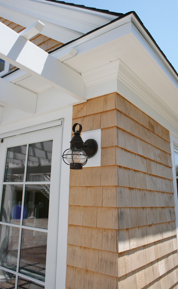 Small beach style one-storey exterior in Providence with wood siding, a gable roof and a shingle roof.