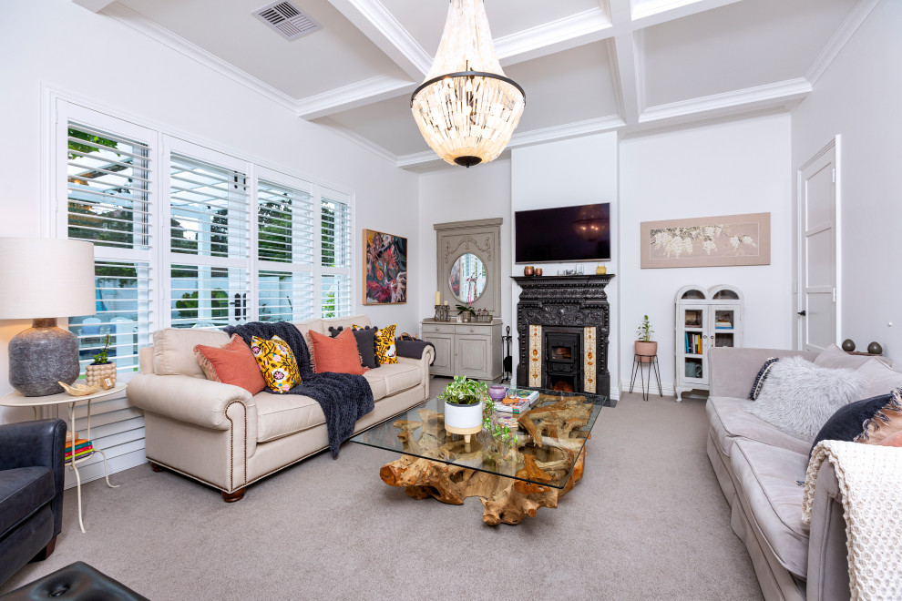 Design ideas for a large beach style enclosed family room in Perth with white walls, carpet, a wood stove, a metal fireplace surround, a wall-mounted tv, beige floor and coffered.