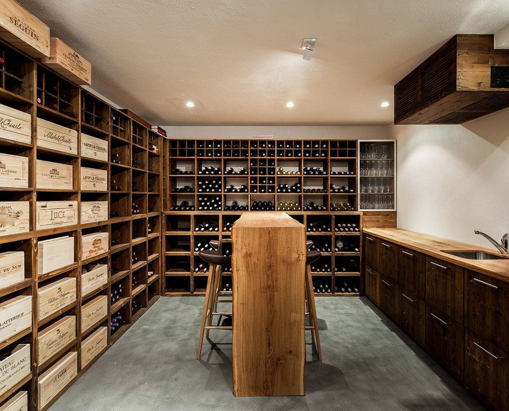 Design ideas for a mid-sized modern wine cellar in Munich with storage racks and grey floor.