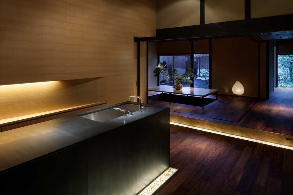 This is an example of an asian open plan kitchen in Kyoto with a drop-in sink and brown floor.