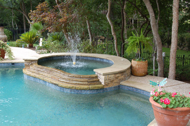 Photo of a mid-sized country backyard rectangular pool in Dallas with a hot tub and natural stone pavers.