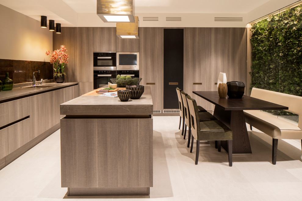 This is an example of a contemporary l-shaped eat-in kitchen in London with an undermount sink, flat-panel cabinets, medium wood cabinets, brown splashback, panelled appliances, with island and beige floor.