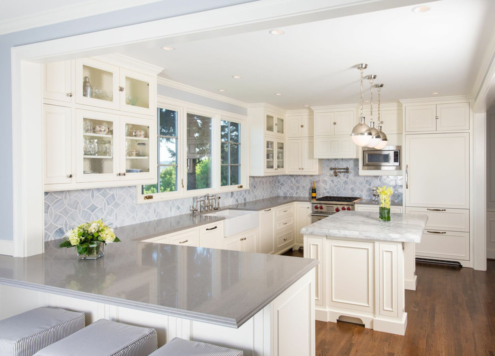 Traditional u-shaped kitchen in Seattle with glass-front cabinets.